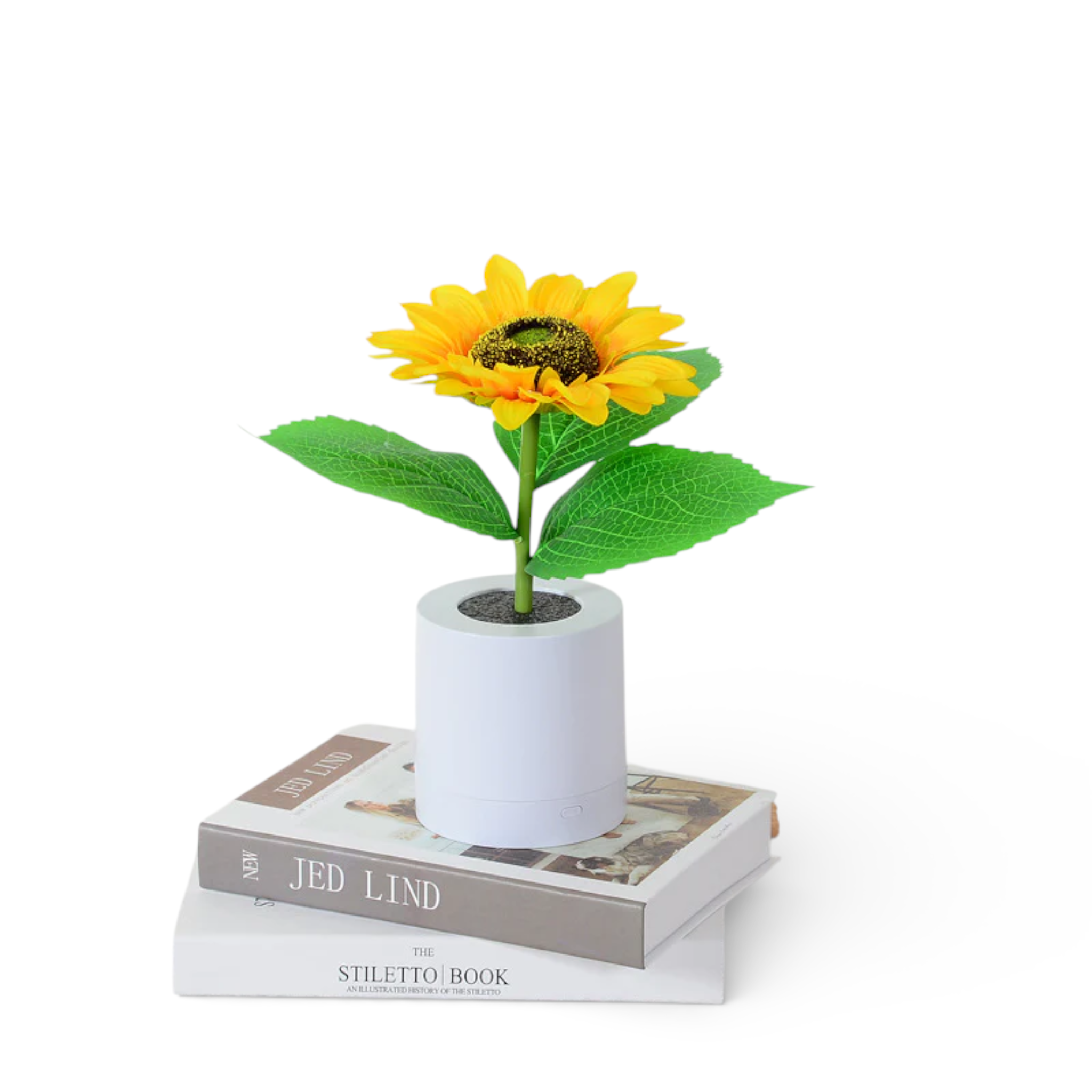 Artificial sunflower in white pot on stacked books, minimalist home decor