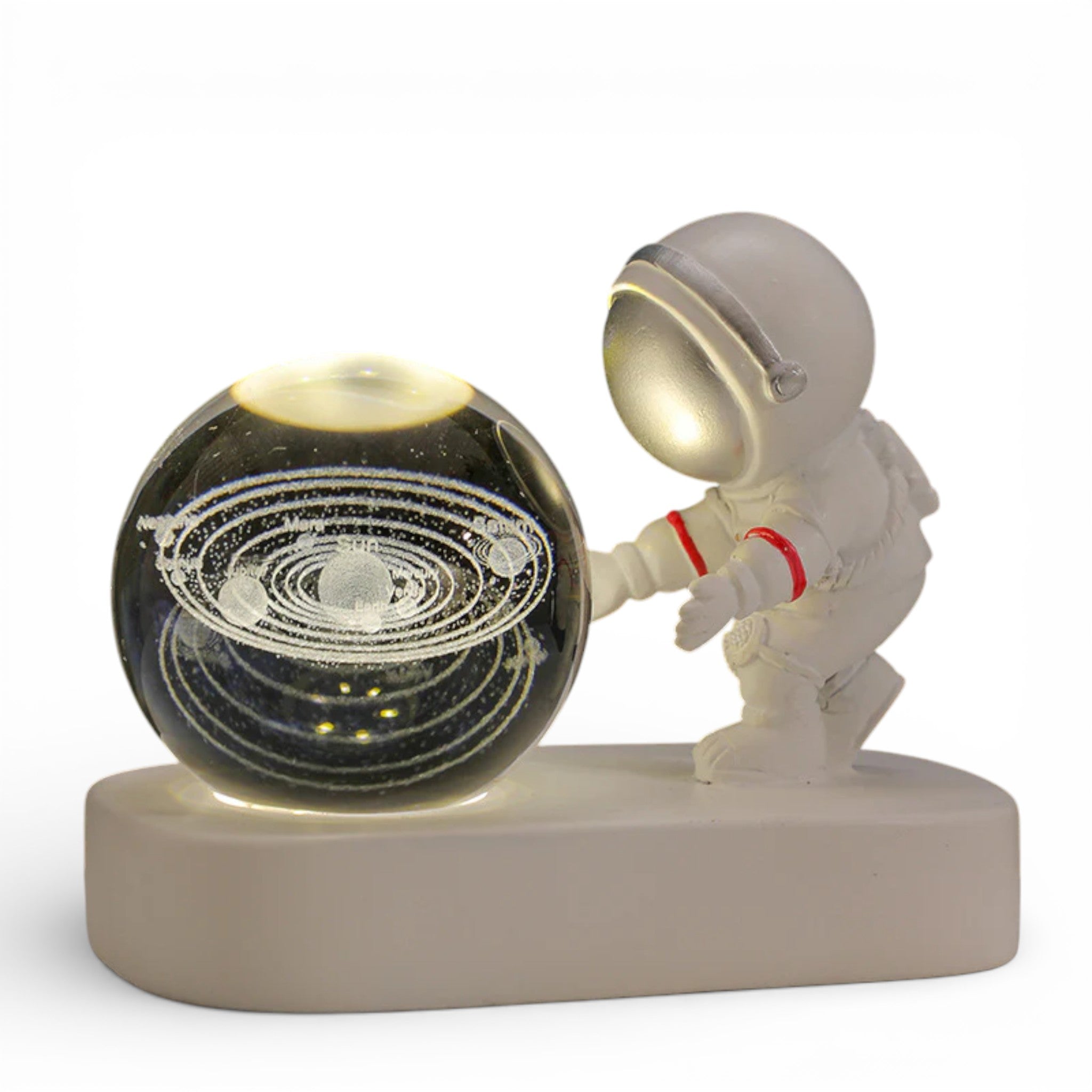 Astronaut figurine with illuminated glass sphere featuring etched solar system design