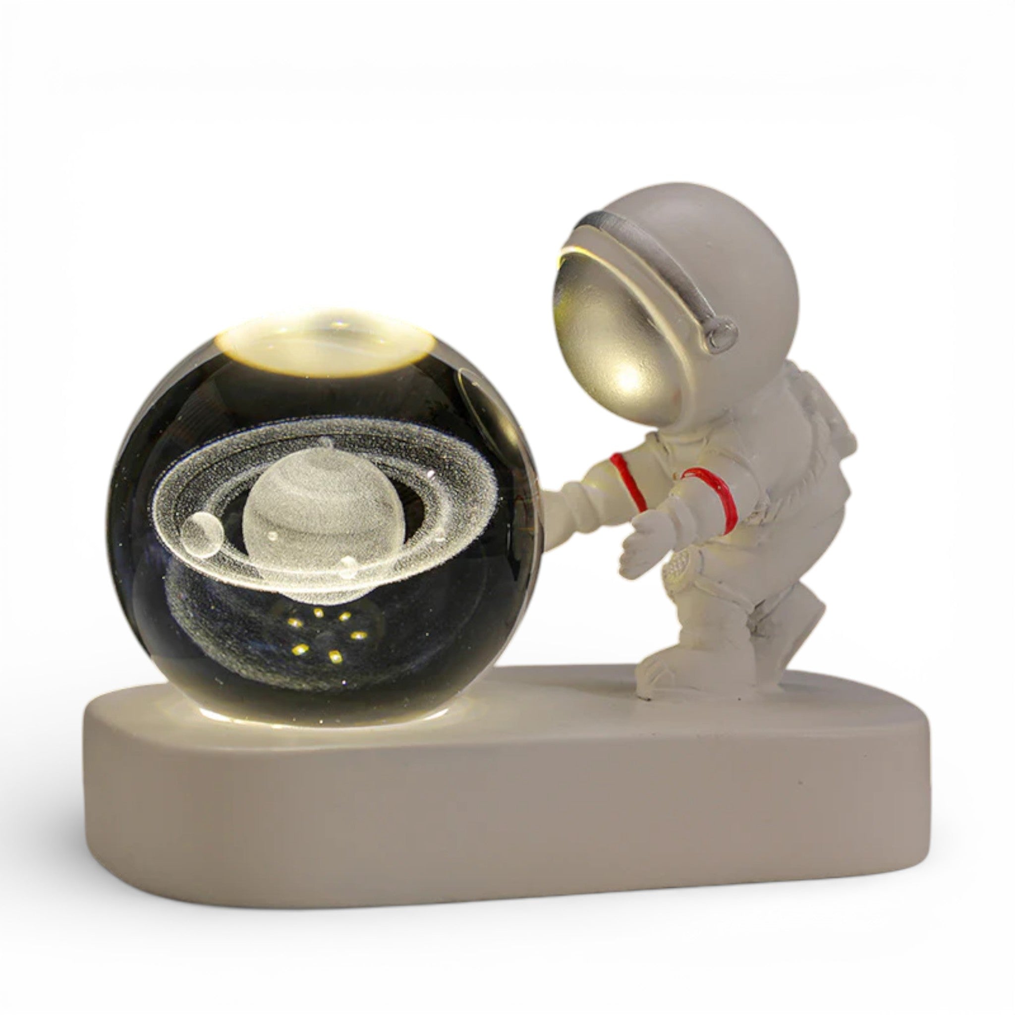 Astronaut figurine with illuminated glass orb featuring Saturn planet model on a white base